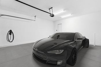 a black and white photo of a car in a garage